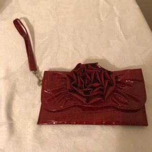 Red patent leather wristlet clutch w rose details